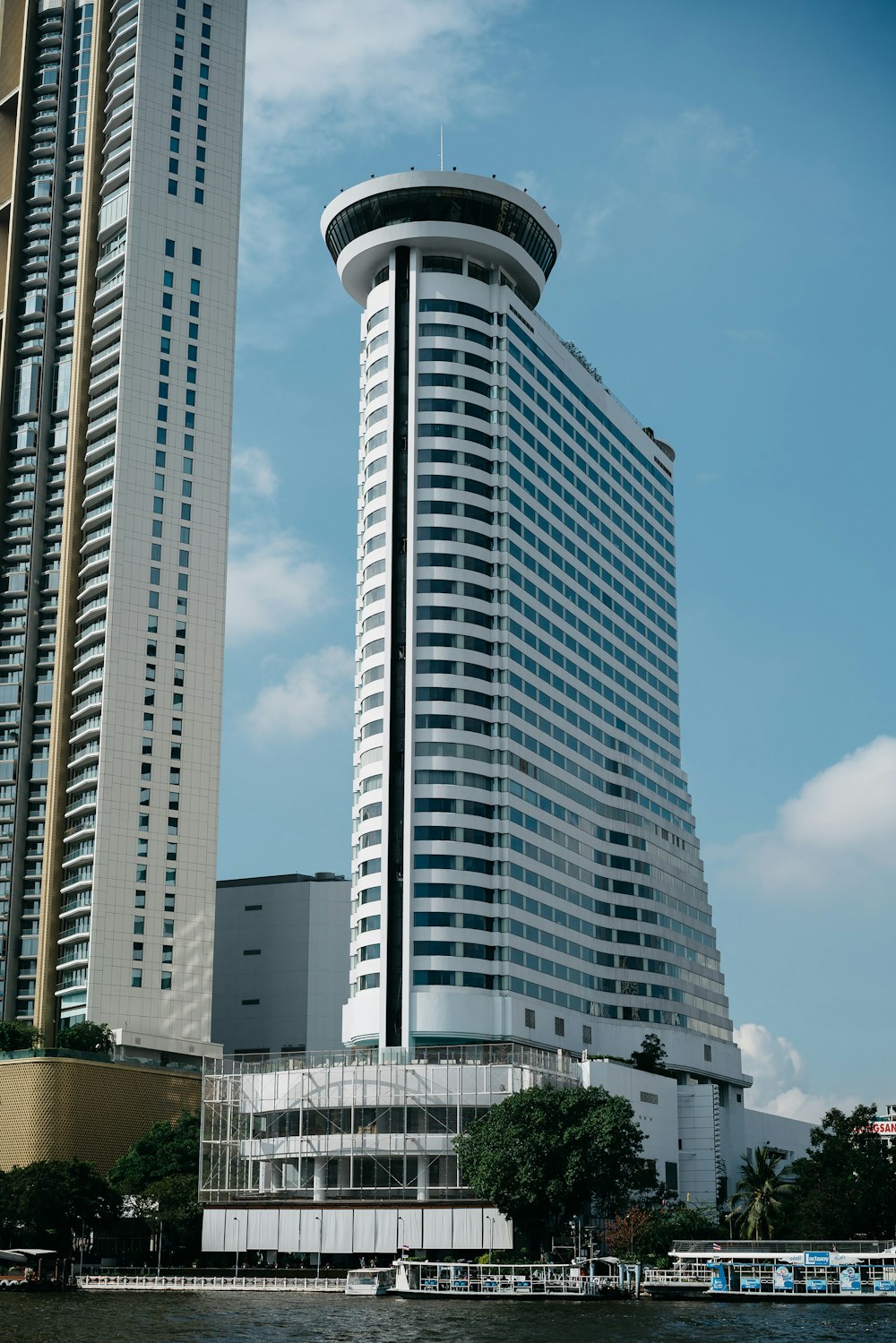 a couple of tall buildings next to a body of water