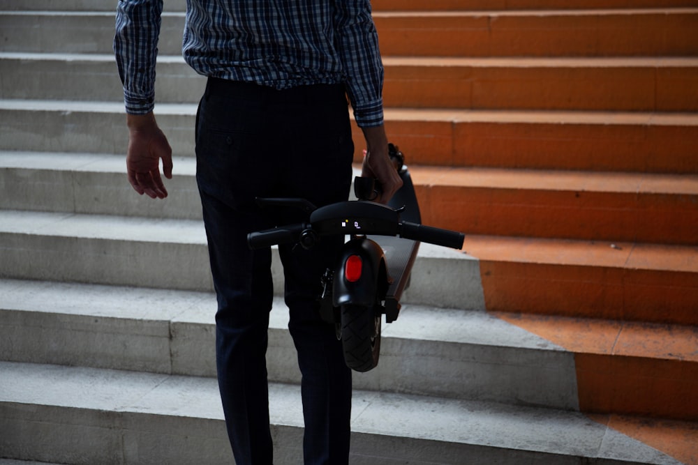 a person walking up stairs with a bike