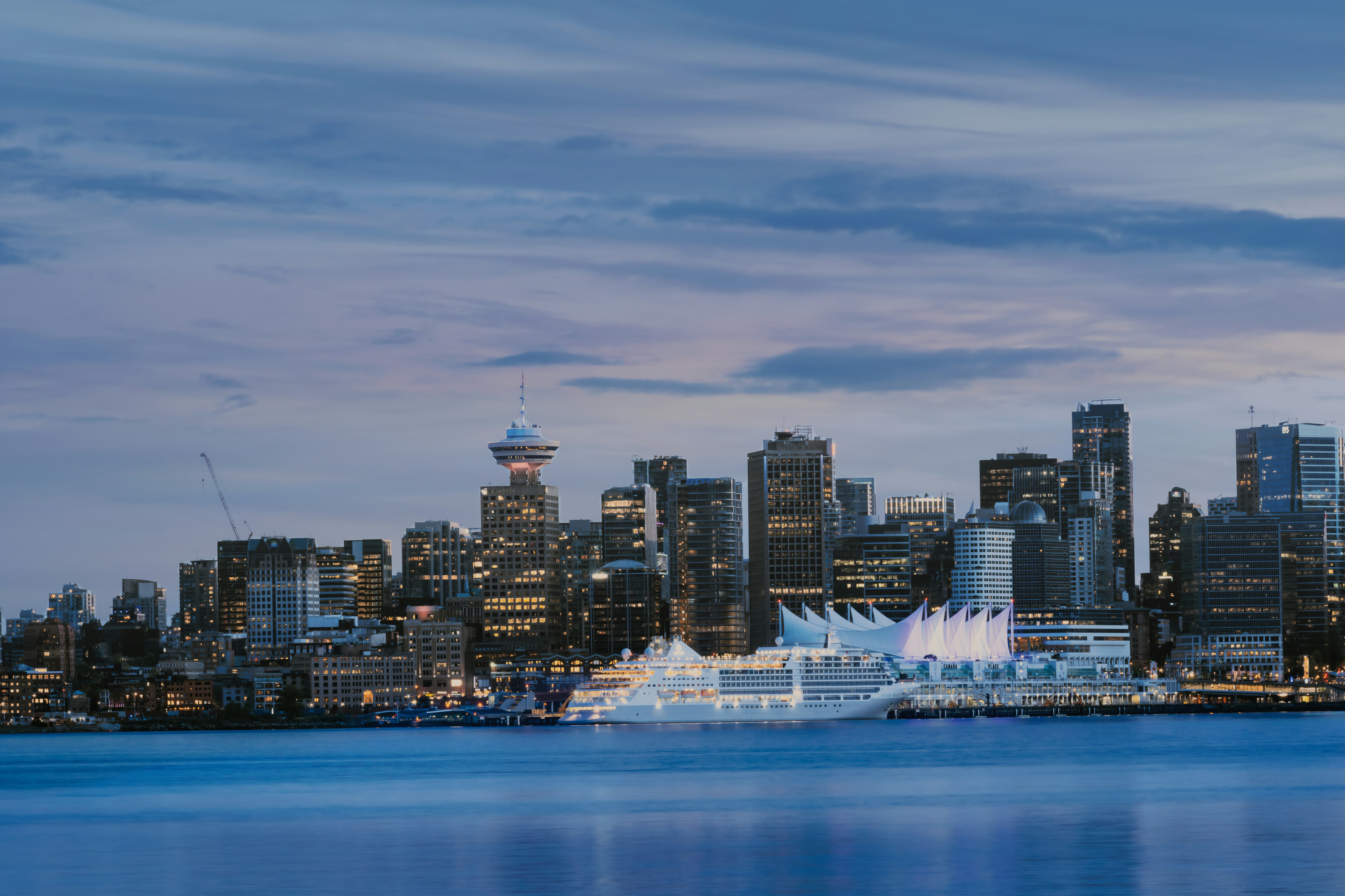 a city skyline with a body of water in the foreground