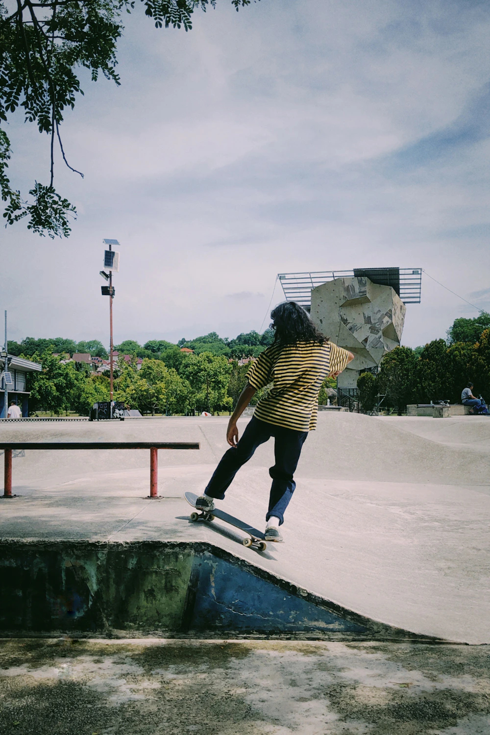 Skateboarder steadying themselves on a concrete ramp during practice