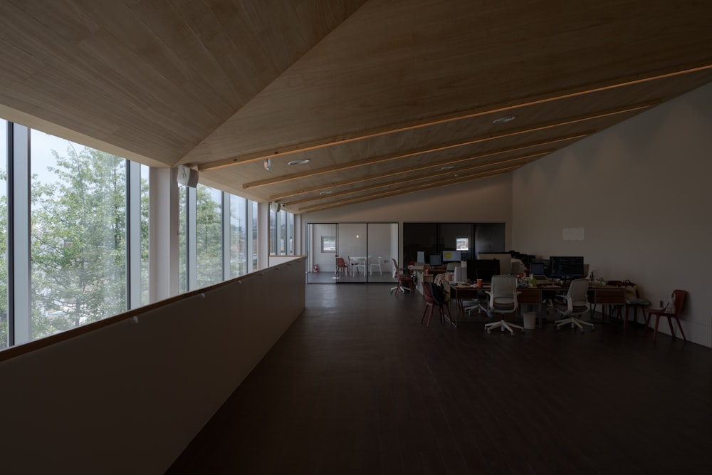 a room with a large window and a group of chairs