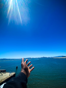 Close-up of a handshake between a boat seller and buyer on a sunny pier