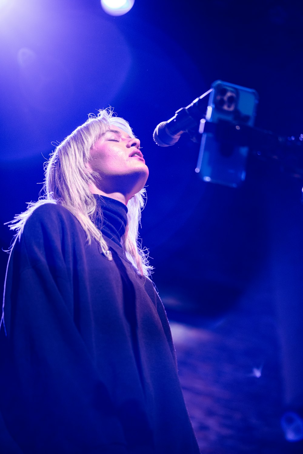 a woman singing into a microphone