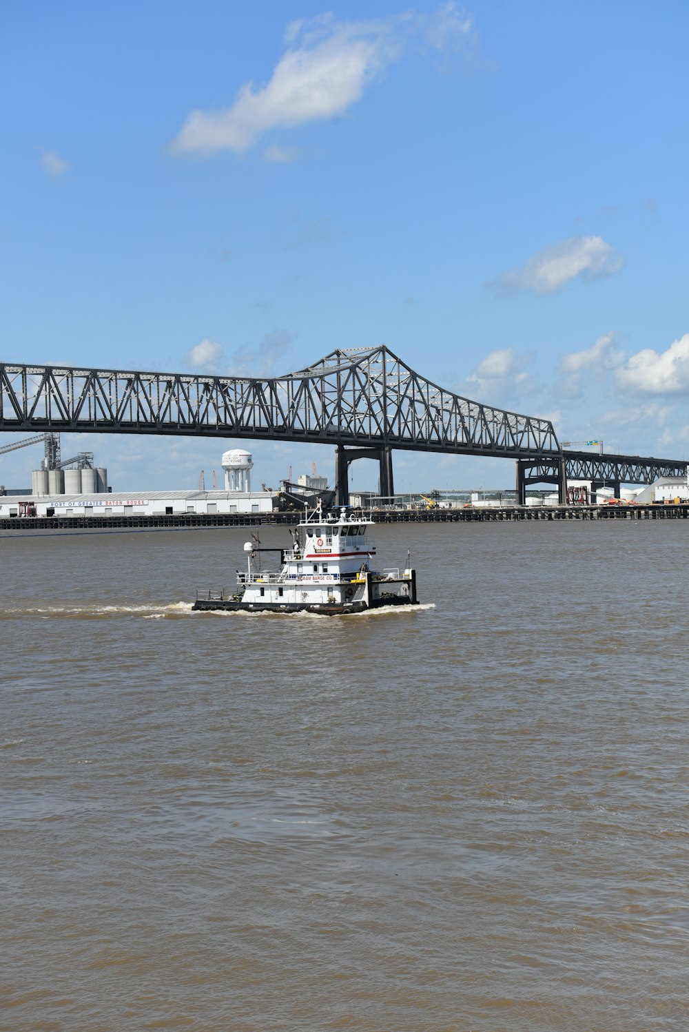 a boat sailing under a bridge