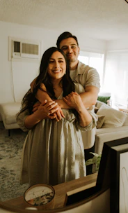 Happy young couple reviewing mortgage options in a cozy living room.