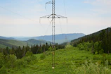 Transmission infrastructure stretching across a green landscape, symbolizing connectivity.