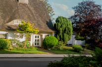 A welcoming front porch of a well-kept residential home bathed in warm sunlight.