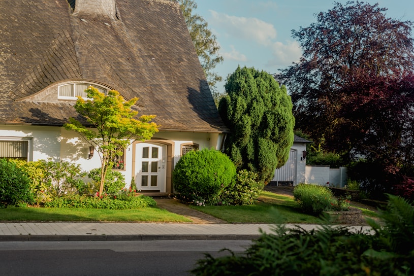 A cozy house with a welcoming front porch bathed in warm sunlight.