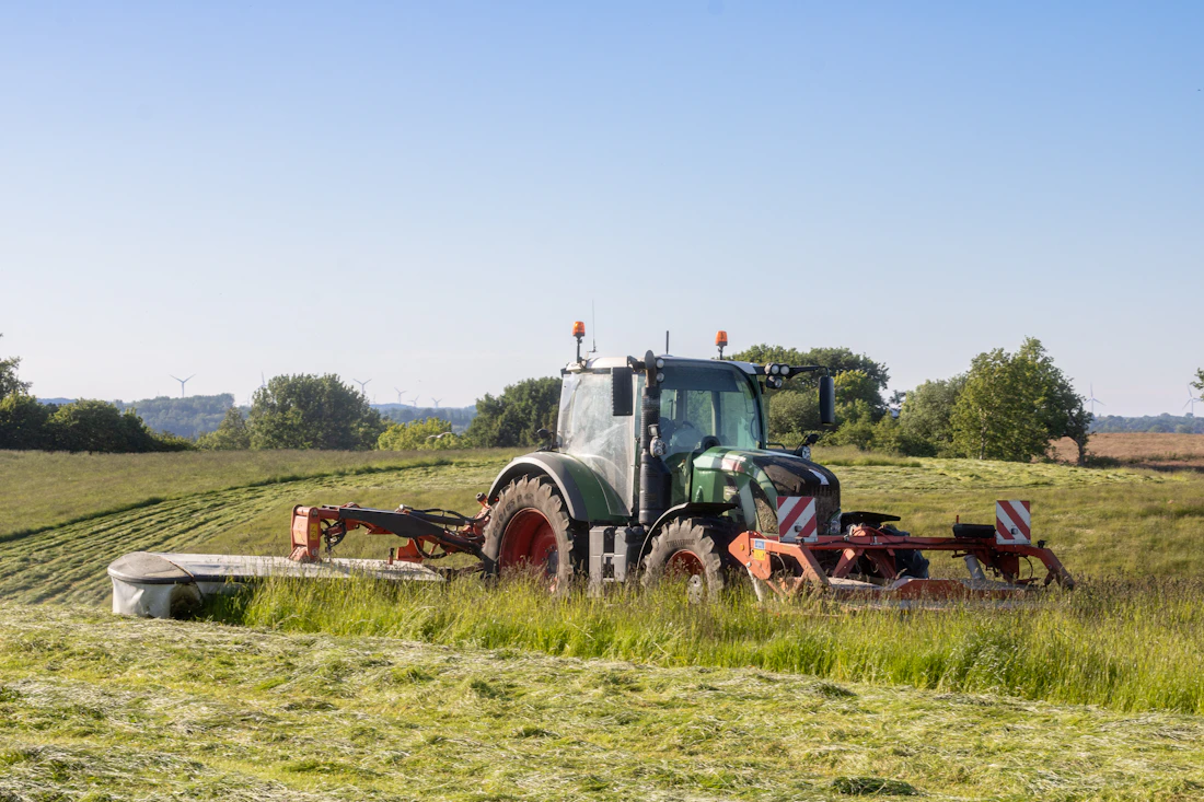 Tractor brush hogging an overgrown field