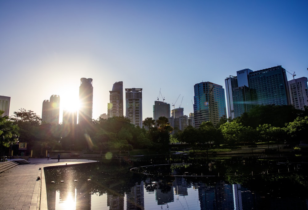 a city skyline with a body of water in front of it