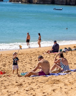 A family enjoying a beachcomber quest with a QR code on a sunny shore.