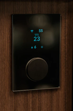Thermal comfort measurement setup with digital displays in a modern office.