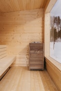 Traditional Finnish sauna with stone heater and wooden walls.