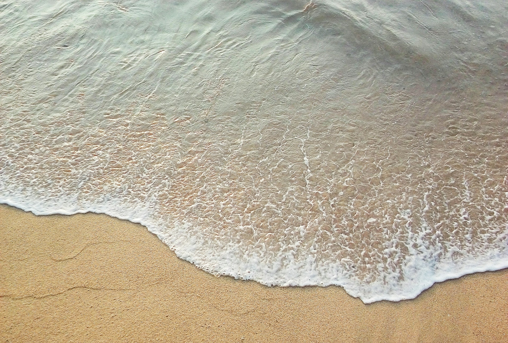 a body of water with sand
