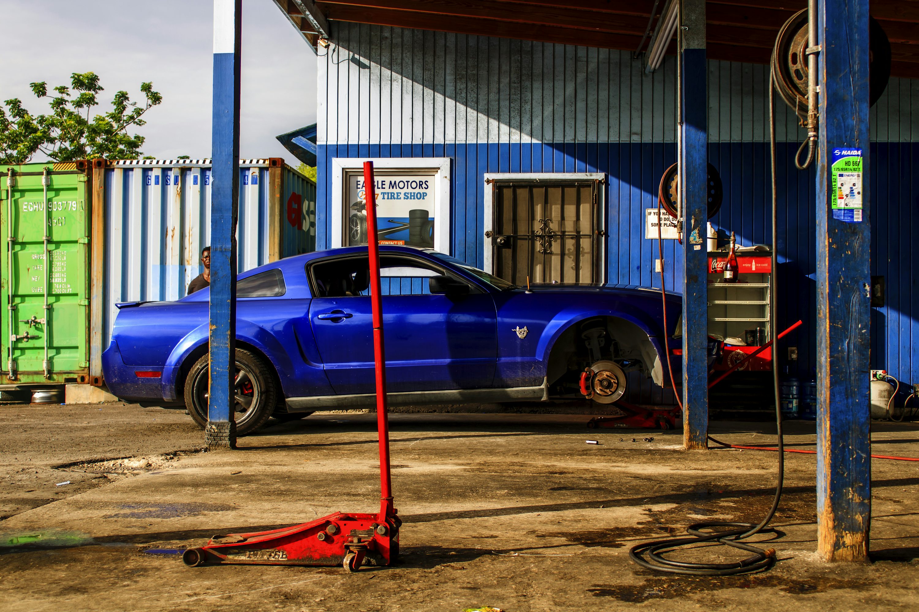 a blue car parked in front of a building