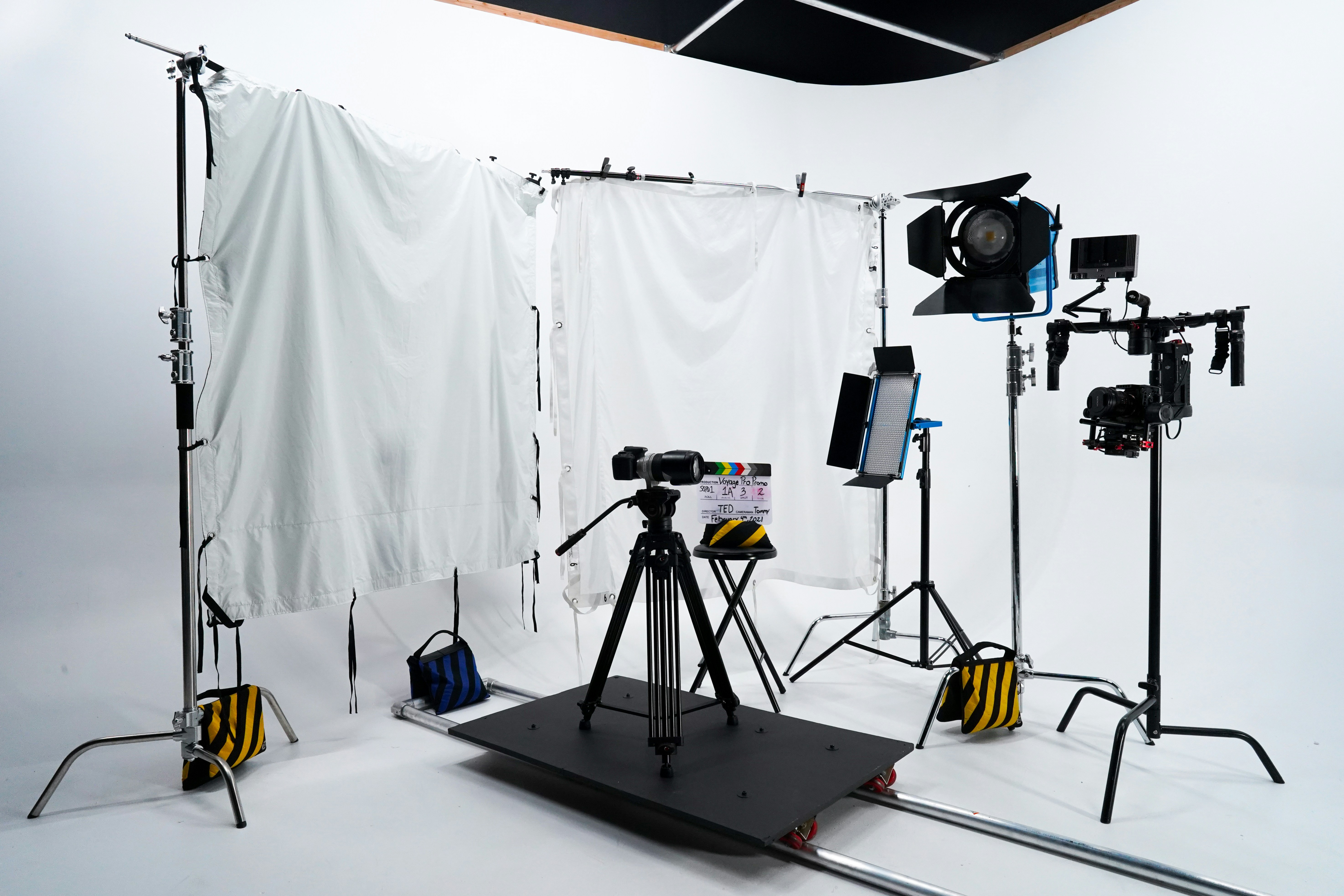 film camera on tripod shooting video studio set with soft lights
