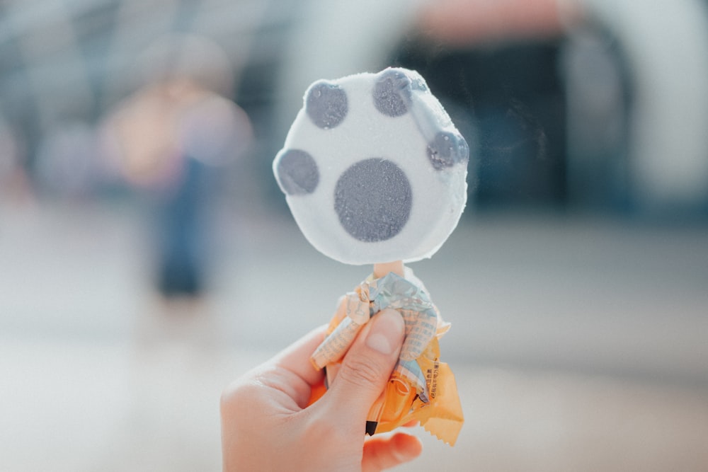 a hand holding an ice cream cone