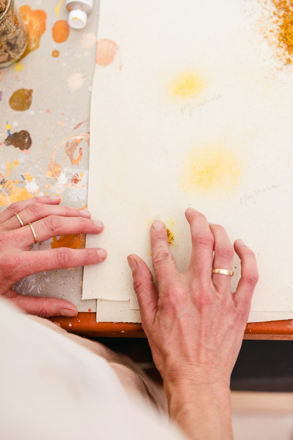 a person's hands holding a white board