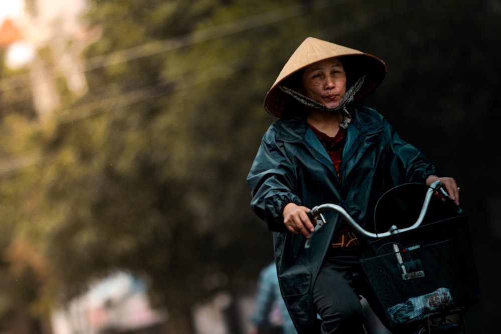 a person in a hat riding a bicycle