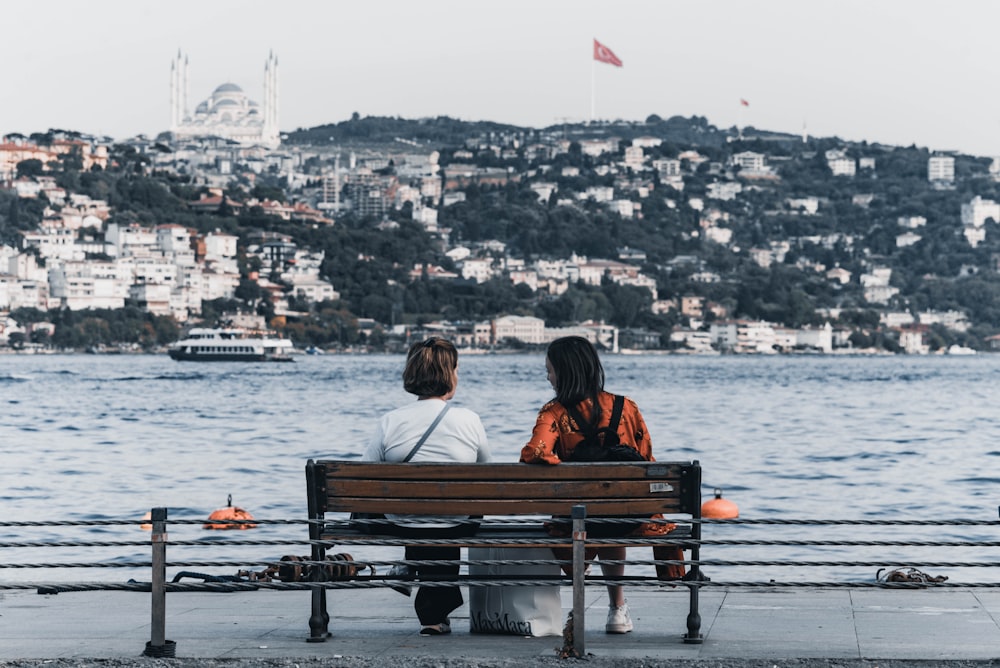 a couple sits on a bench