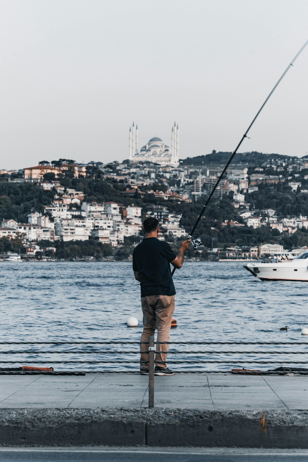 a man fishing on a pier
