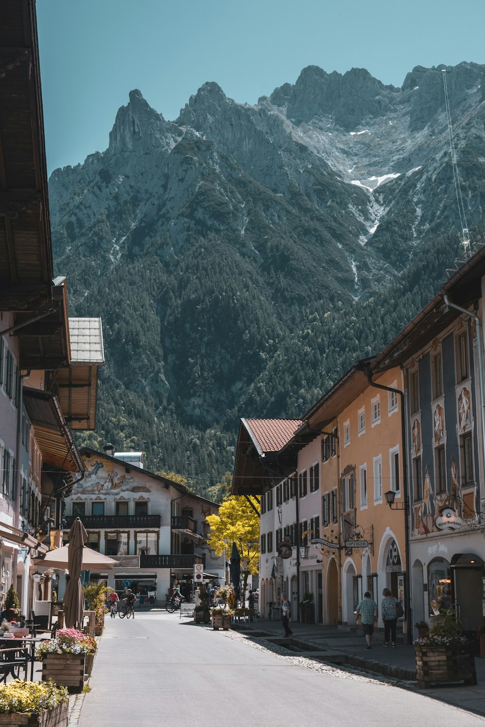 a street with buildings and a mountain in the background