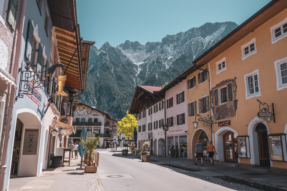 a street with buildings and mountains in the background