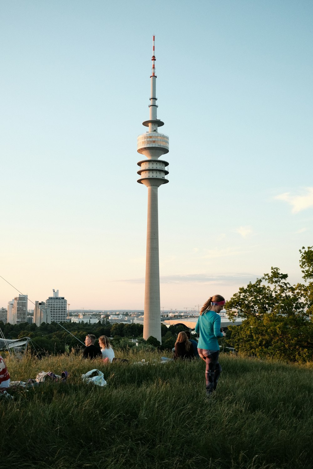 a tall tower in a park with Olympiaturm in the background