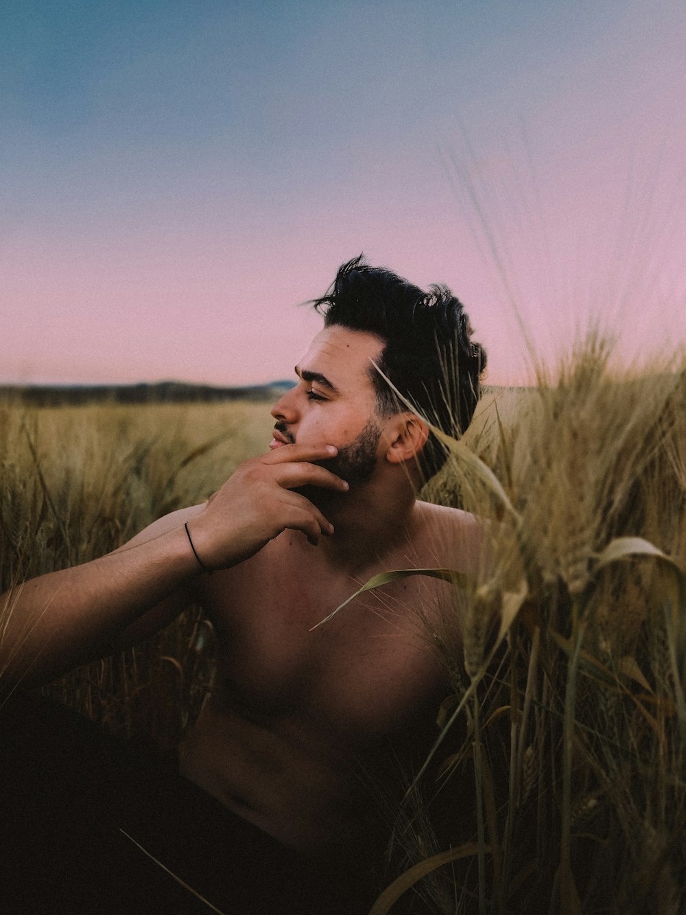 a man with a beard in a field of wheat