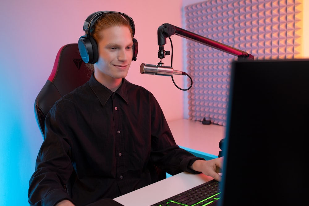 a man wearing headphones and sitting at a computer