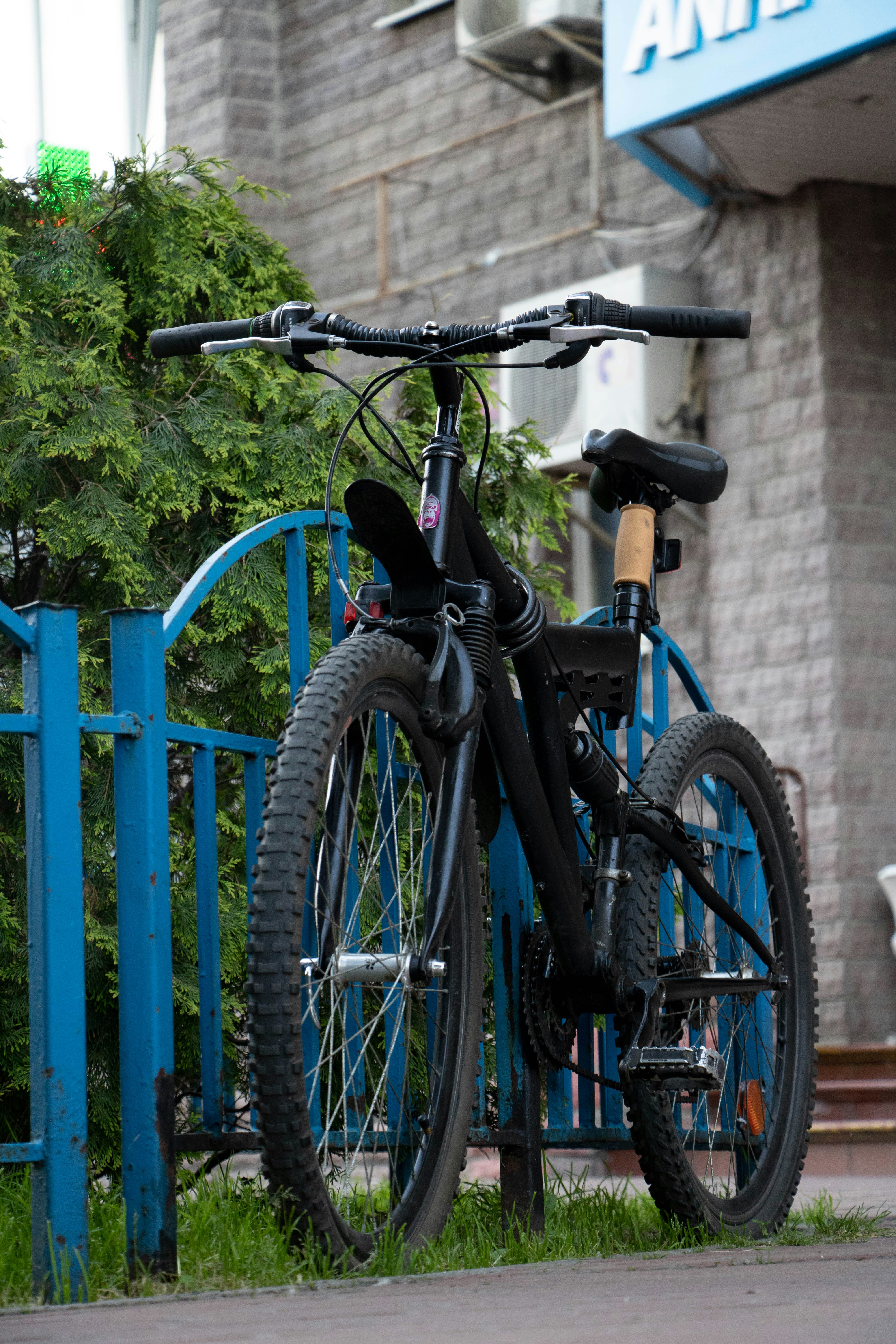 a bicycle leaning against a blue fence