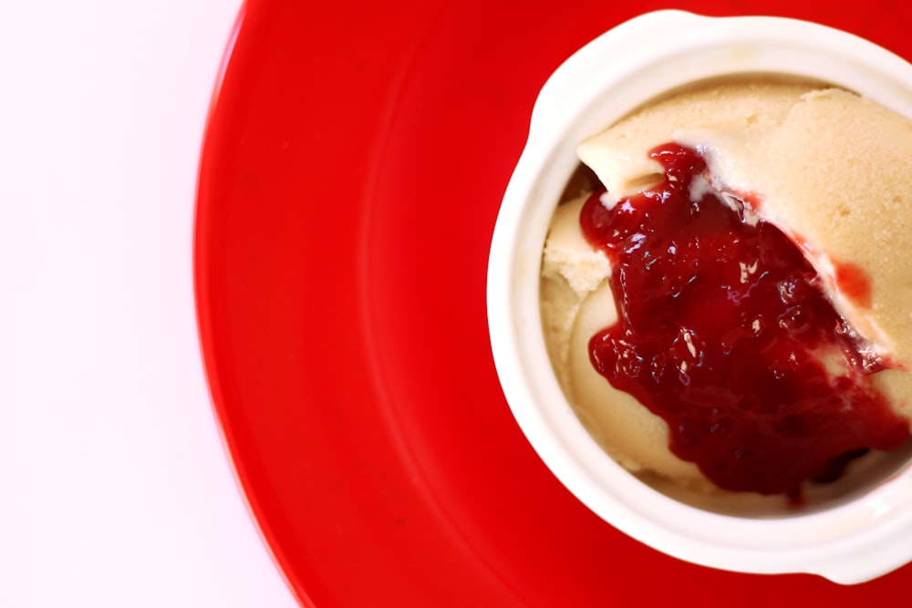 a red bowl with a white substance and a red bowl with a white substance in it