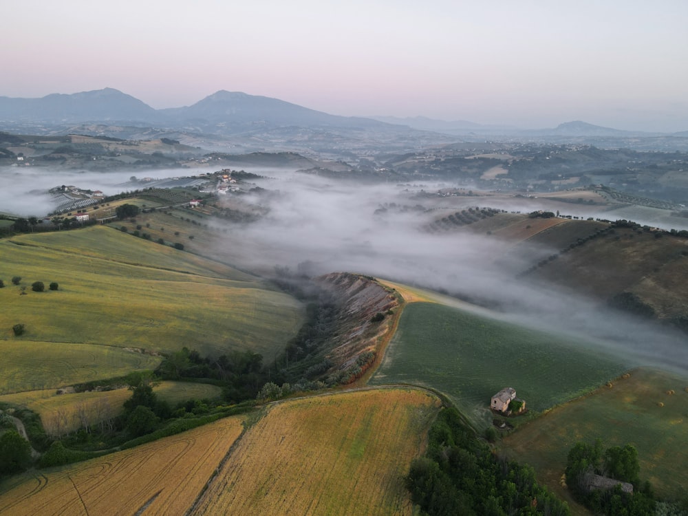 a landscape with hills and a body of water in the distance