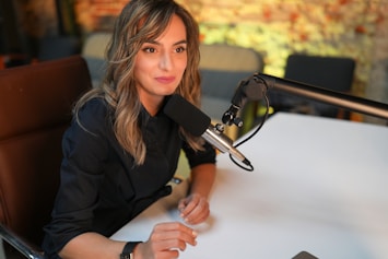 a woman sitting at a table with a gun