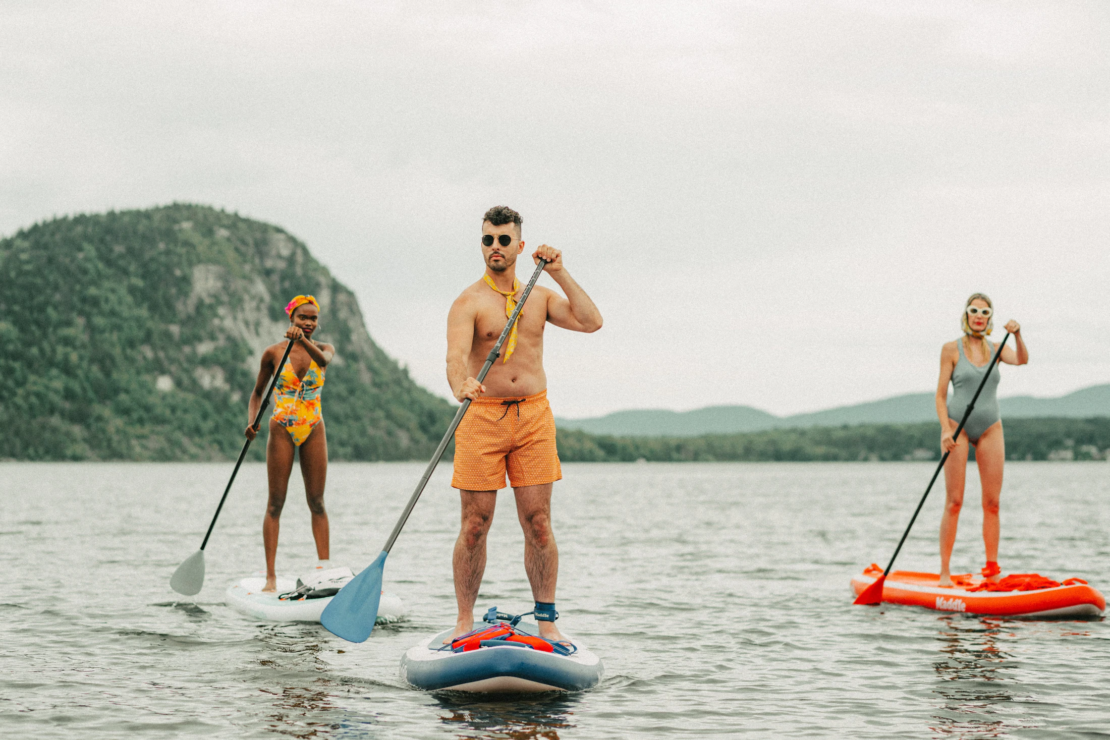 Group of people paddleboarding together on calm water