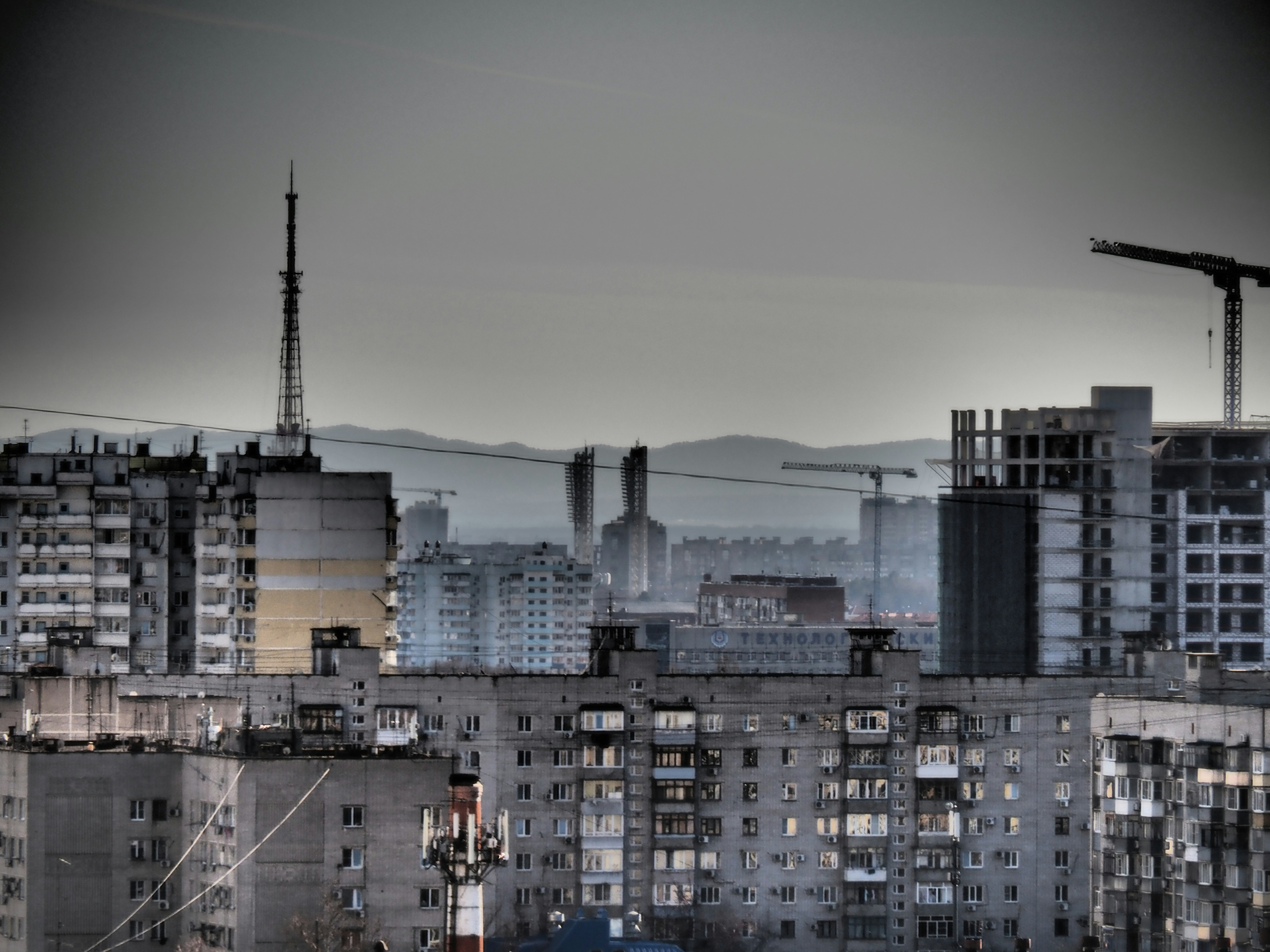a city with buildings and cranes