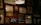 A wall adorned with various framed artworks and photographs, including images of a bicycle, inspirational quotes, and abstract designs. The lighting is warm and subtle, with a prominent hanging lamp creating a cozy atmosphere.