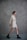 A person in a light-colored outfit walks against a textured gray wall, showcasing a relaxed and stylish fashion choice with a combination of a bralette, shorts, and an open shirt. Black combat boots complement the casual look. The hair is styled in a bun, adding to the polished appearance.