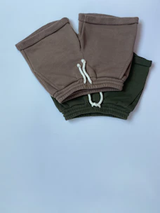 A pair of flexible, durable training shorts laid out on a wooden bench.