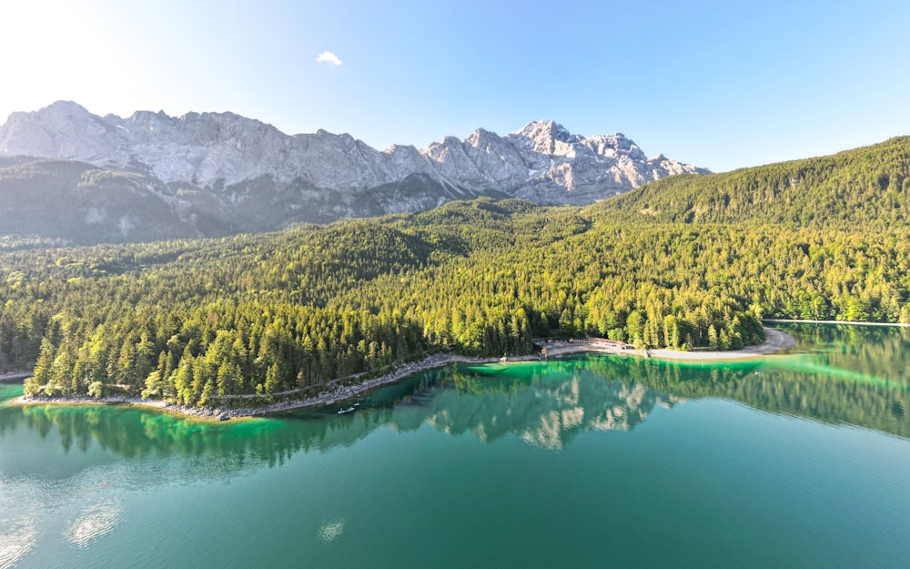 a lake with trees and mountains in the background