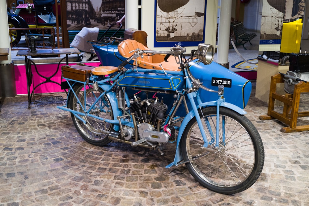 a blue motorcycle parked in a shop