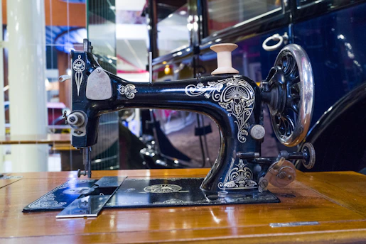 A sleek modern domestic sewing machine displayed on a clean white background.