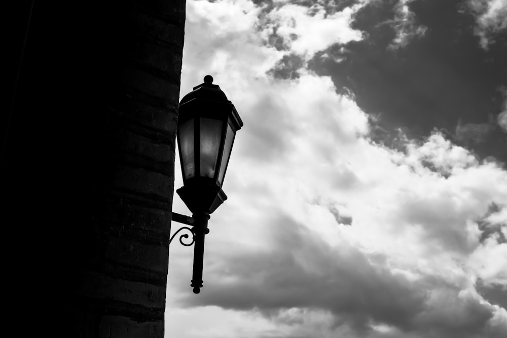 a lamp post with clouds in the background