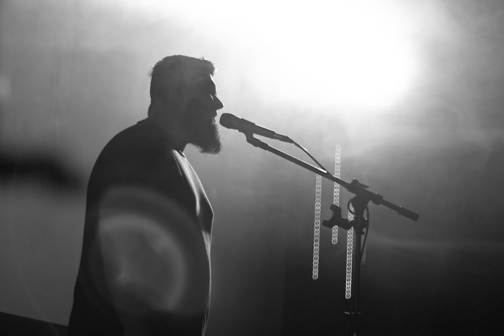 a man standing at a microphone