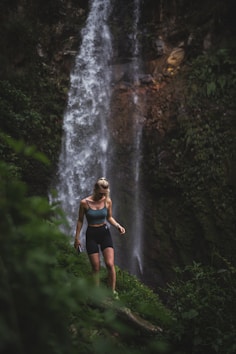 a person standing in front of a waterfall