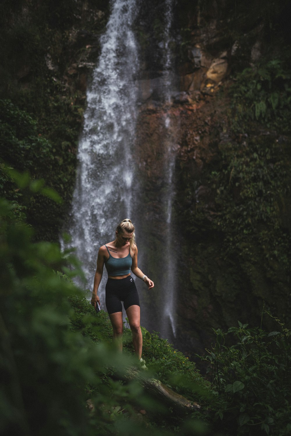 a person standing in front of a waterfall