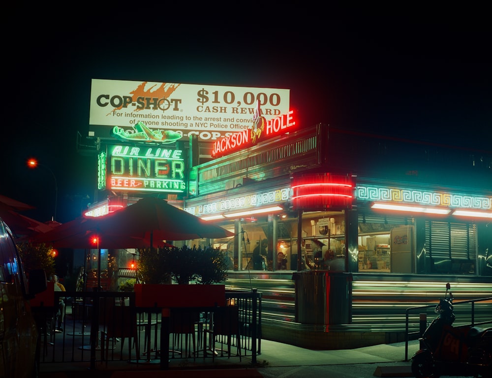 a restaurant with neon signs