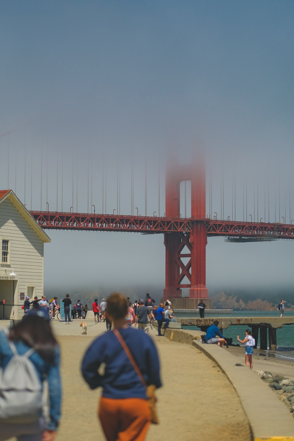 a group of people walking on a bridge