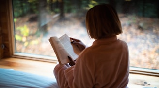 a person sitting in front of a window