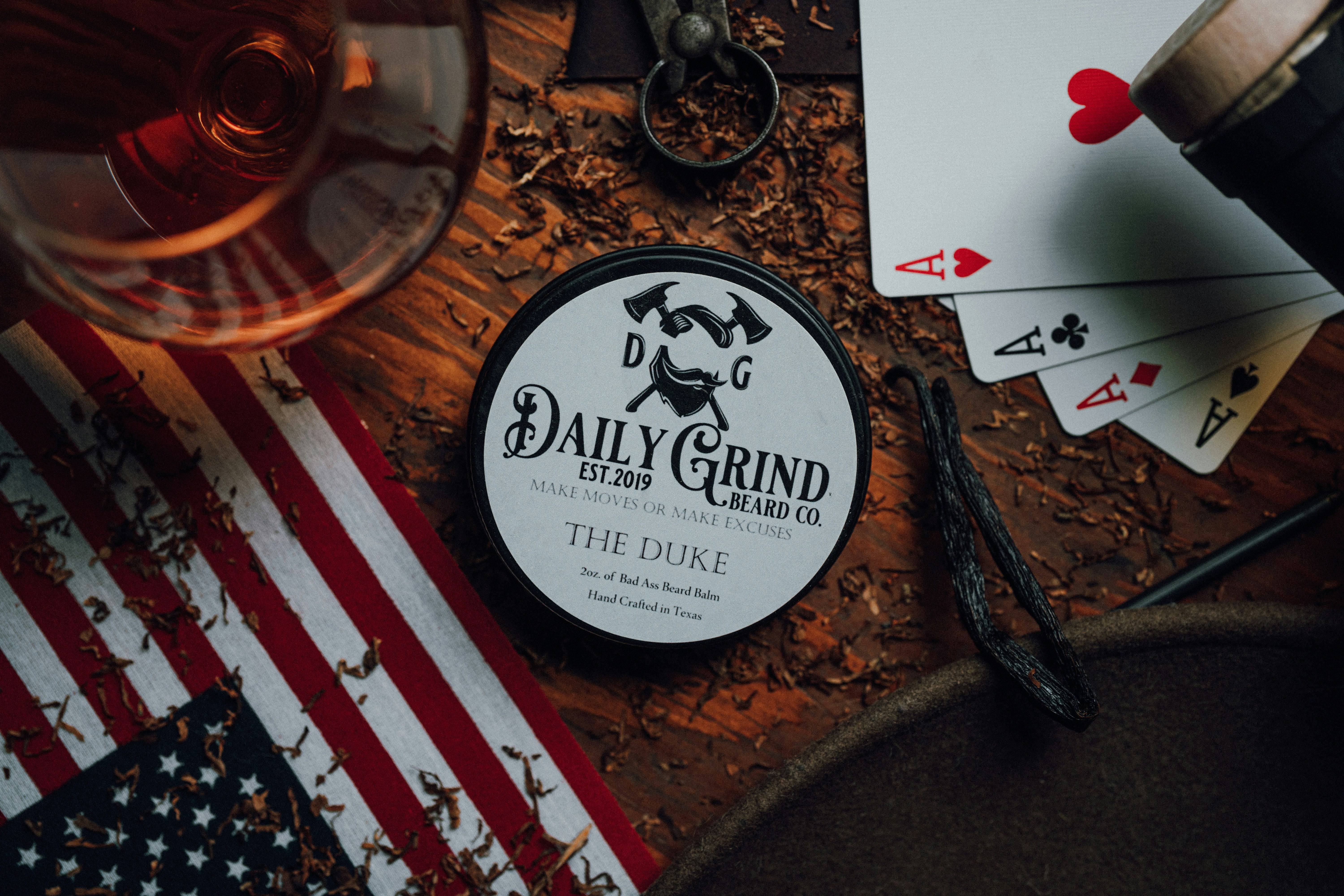 Masculine gift set with watch leather wallet and whiskey on dark wooden surface